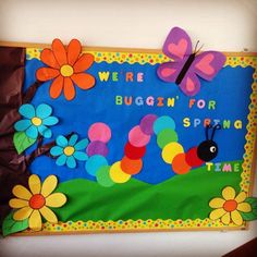 there is a bulletin board with flowers and a butterfly on it that says, we're buggin for spring