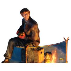 a man sitting on top of a wooden bench next to a fire pit and holding an object