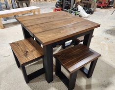 a wooden table with two benches next to it