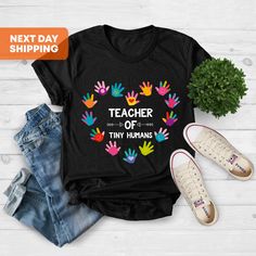 "Tiny Human Tamer, Teacher Shirt, Teacher Gifts, Preschool Teacher Gift, I Teach Tiny Humans, Teacher Group Shirts, Gift For Teacher Hi! Welcome. It's great to see you here! ☺️ Our shirts are clean, high quality and soft. It is prepared quickly by our boutique. Ironing and shipped. Enjoy your shopping! It is a pleasure for us to help you with your questions and you can reach us at any time. Please, don't forget to check our size cards. HOW TO ORDER SHIRT 👕 Please, choose your favorite t-shirt c Teacher Gifts Preschool, I Teach Tiny Humans, Tiny Human Tamer, Preschool Teacher Gifts, Preschool Gifts, Group Shirts, Preschool Teacher, Gift For Teacher, Tiny Humans