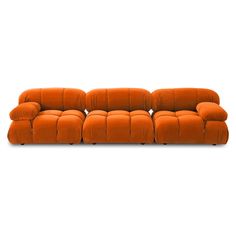 an orange couch sitting on top of a white floor