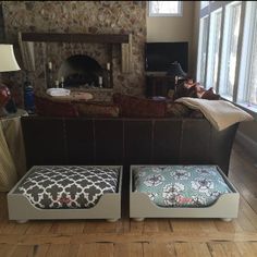 two foot stools sitting in front of a stone fireplace