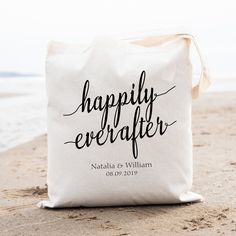 a tote bag that says happily everafter on it sitting in the sand