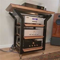 a stereo system sitting on top of a wooden shelf