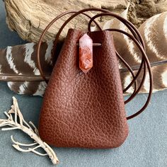 "Leather Medicine Bag, Shaman Bag or Amulet Pouch to wear around your neck-or hang in your Car! Perfect for Ceremony or to wear to a Festival...or even to wear everyday! These are made from the last few pieces of soft Brown Leather I have. There's a bit of variety,as you can see in the Video. The Stones have variety too-that's the beauty of these particular Stones! 2 Color Choices: *The Dark Chocolate features very large pieces Montana Agate. *The Rusty Brown has my favorite Stone-Lepidocrocite Necklace Pouch, Ceremony Altar, Leather Medicine Bag, Yoga Spiritual, Bag Necklace, Medicine Pouch, Red Quartz, Medicine Bag, Crystal Bags