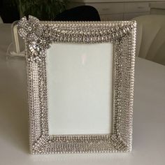 an ornate silver frame sitting on top of a table