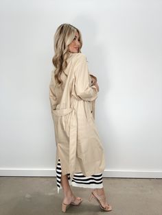 Introducing our Oversized Trench Coat, the ultimate transition piece for a sophisticated and elevated look. With pocket details, button closures, and a collared neckline, this long trench coat is not only stylish, but also soft and comfortable. The neutral color and waist tie detail make it perfect for layering, keeping you warm and chic for any occasion, from dinner to drinks or shopping. Classy, just like you. Fabric 80% Polyester, 20% Cotton Lining 97% Polyester, 3% Spandex Dry clean only. Chic Single Breasted Outerwear For Day Out, Chic Single-breasted Outerwear For Day Out, Oversized Beige Raincoat For Fall, Classic Long Raincoat For Fall, Elegant Single Breasted Outerwear For Everyday, Elegant Single Breasted Outerwear For Day Out, Elegant Single-breasted Everyday Outerwear, Elegant Single-breasted Outerwear For Day Out, Spring Long Coat Outerwear With Button Closure