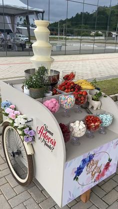 an ice cream cart is decorated with flowers and fruit