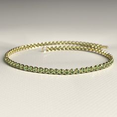 This 1.97 Carat Peridot Dainty Tennis Bracelet in 14K gold is a stunning homage to the August birthstone. Handcrafted with precision, its vibrant green peridot stones are set in a delicate design, perfect for any occasion. Whether stacked or worn alone, this customizable bracelet makes a thoughtful birthday gift for her. Elevate her jewelry collection with this timeless, elegant piece, meticulously designed for sophistication and style. 𝐅𝐞𝐚𝐭𝐮𝐫𝐞𝐬: * 𝐌𝐚𝐝𝐞 𝐭𝐨 𝐎𝐫𝐝𝐞𝐫 * 𝐌𝐞𝐭𝐚𝐥: Green Bangle Tennis Bracelet For Anniversary, August Birthdays, Stacked Wedding Rings, Birthstone Bracelet, August Birthstone, Jewelry Birthday, Delicate Design, Birthstone Bracelets, Band Bracelet