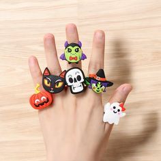 a hand with five halloween rings on it