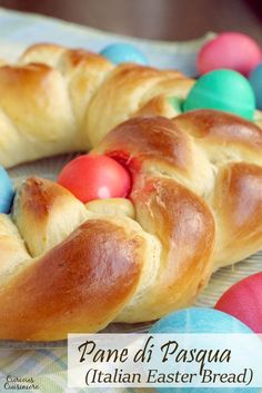 a croissant with colored eggs in the shape of an easter egg on it