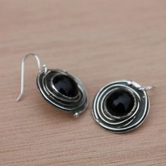 I hand crafted these earrings out of sterling silver and bezel set a black onyx in the center, adding some oxidizer for depth and character, and a shiny buffed finish. Each pair of earrings is totally handmade and unique! Now available in 1/2", 5/8" and 3/4" circle size---french wires are sterling silver,too! Perfect for casual and business wear accessory~looks great with almost anything! **Matching necklaces are available Material: Silver (.925). All materials are hypoallergenic. These Earrings Polished Onyx Earrings For Gift, Unique Round Earrings With Polished Finish, Nickel-free Silver Onyx Earrings, Black Drop Earrings With Oxidized Finish, Silver Onyx Earrings Perfect As A Gift, Black Sterling Silver Jewelry With Oxidized Finish, Black Oxidized Sterling Silver Jewelry, Onyx Round Earrings For Gift, Nickel-free Black Round Earrings