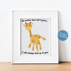 a giraffe is shown in a white frame on a wooden table with the words, no matter how tall i grow