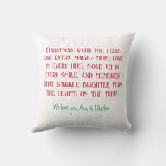 a white pillow with red and green lettering on the front that says christmas with you