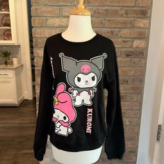 New Without Tags This Adorable Black Crew Neck Sweatshirt Has Kuromi & My Melody On The Front And The Back! Perfect For The Hello Kitty Fan / Collector! 60% Cotton 40% Polyester Size Large Pit To Pit Measures Approx 22” Size Medium Pit To Pit Measures Approx 21.5” 5 Star Seller Fast Shipping Carefully Packaged Smoke Free Home Bundle & Save On 3+ Items Low Offers Declined New To Poshmark? Enter The Code Julesetc08 When You Sign Up And Receive $10 Off Your First Order! Harajuku Hello Kitty Crew Neck Top, Kawaii Black Sweatshirt With Graphic Print, Black Kawaii Sweatshirt With Graphic Print, Kawaii Black Top With Character Print, Black Kawaii Top With Character Print, Cute Black Anime Print Tops, Casual Black Hello Kitty Top, Hello Kitty Hoodie, Hello Kitty Sweatshirt