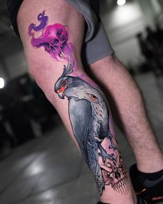 a man with a tattoo on his leg has an owl and skull on it's arm