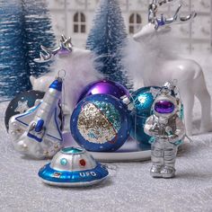 an assortment of christmas ornaments in silver and blue