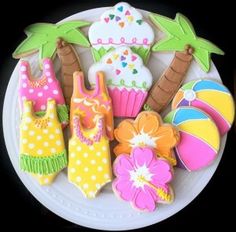 decorated cookies on a plate with palm trees