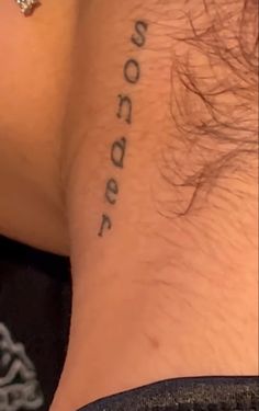 a close up of a person's neck with the word boodader tattooed on it