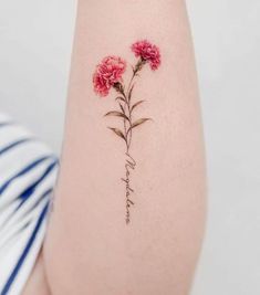 a woman's arm with flowers on it and the word love written in cursive writing