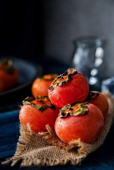 some tomatoes are sitting on top of burlock