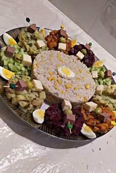 a platter filled with lots of different types of food on top of a table