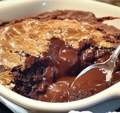 a bowl filled with chocolate pudding and a spoon