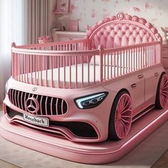 a pink baby's room with a car bed