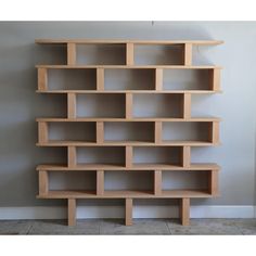 a book shelf made out of wood with several shelves on each side and one in the middle