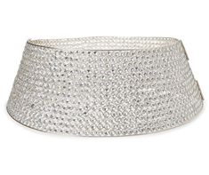 a large silver basket with lots of diamonds on the bottom and sides, sitting on a white surface