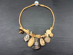 Natural shell charm necklace. Large pendant necklace. Trendy mother-of-pearl and shell necklace. The natural shell charm necklace. It is made up of large dangling shells and small mother-of-pearl beads. The necklace is trendy and boho. It is perfect for summer and for the beach. Shells are natural and come in different species and shapes. Seashells come in different sizes and shapes. Mother-of-pearl pearls are white and pearly. The necklace is long and measures approximately 51 cm. Here are some Handmade Bohemian Shell Charm Necklace, Brown Shell Necklace As A Gift, Shell Charm Necklace, Beach Shells, Large Pendant Necklace, Linen Tshirts, Shell Necklace, White Dress Summer, Shell Necklaces