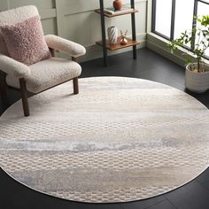 a round rug in a living room with a chair and potted plant on the floor