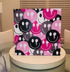 a table topped with a pink and black painting