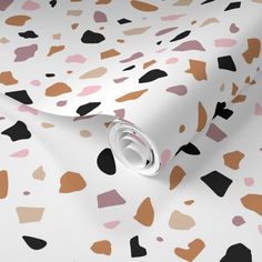 a white and brown wallpaper with black, grey, and orange spots on it