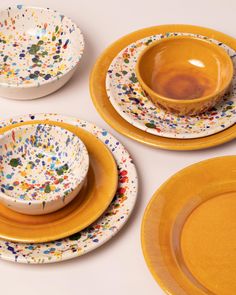 three yellow and white dishes with sprinkles on them