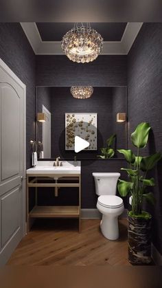 the bathroom is decorated in black and white with gold accents on the ceiling, along with a potted plant