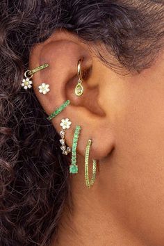 a close up of a person's ear with three different types of piercings