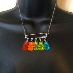 a multicolored necklace is displayed on a mannequin