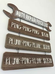 four signs are hanging on the wall in order to show where to put their prices