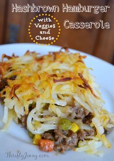 hashbrown hamburger casserole with veggies and cheese on a white plate