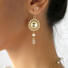 "I created this champagne drop earrings by hand, using Swarovski Rivoli 12mm, Swarovski pearls 5mm, Miyuki round seed beads, Miyuki Delica beads, and 14k goldfilled ear-wire * Measurements: Earring length: 2.36\" (6cm) Pendant diameter: 0.78\" (2cm) * The earrings will come beautifully packaged for a gift. * For other Bridal earrings: https://www.etsy.com/ca/shop/LioraBJewelry?ref=listing-shop2-all-items-count%C2%A7ion_id&section_id=16552834 * my shop: https://www.etsy.com/shop/LioraBJewelry Crystal Drop Earrings Wedding, Beaded Wedding Jewelry, Drop Earrings Wedding, Crystal Cluster Earrings, Champagne Earrings, Swarovski Crystal Drop Earrings, Handmade Beaded Earrings, Crystal Teardrop Earrings, Golden Shadow