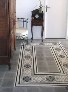 a room with a chair and a rug on the floor next to an open door