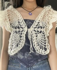 a close up of a person wearing a shirt with lace on it and a necklace