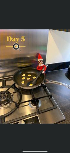 an elf is sitting on top of a frying pan with the words day 5