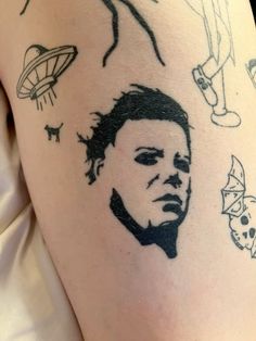 a person with tattoos on their legs and arm, has an image of a man's face