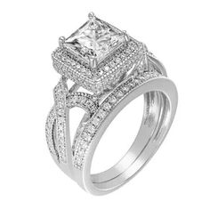 a white gold ring set with two princess cut diamonds on the sides and an intricate band