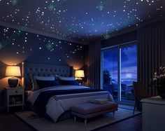 a bed room with a neatly made bed and stars on the wall above it at night