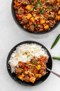 two black bowls filled with meat and rice on top of a white countertop next to green beans