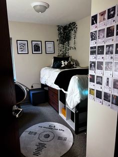 a bed room with a neatly made bed and pictures on the wall