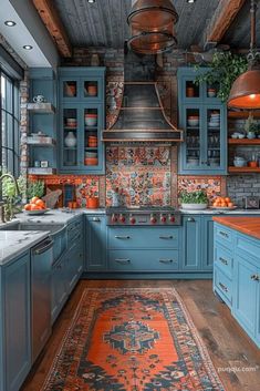 a kitchen with blue cabinets and an orange rug